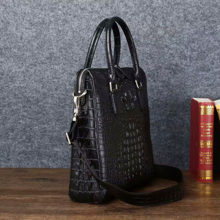 Structured croc-embossed briefcase side view showing ridged spine and detachable shoulder strap
