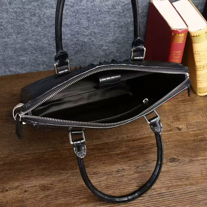 Black alligator-pattern leather briefcase lifestyle shot beside classic books on wooden desk
