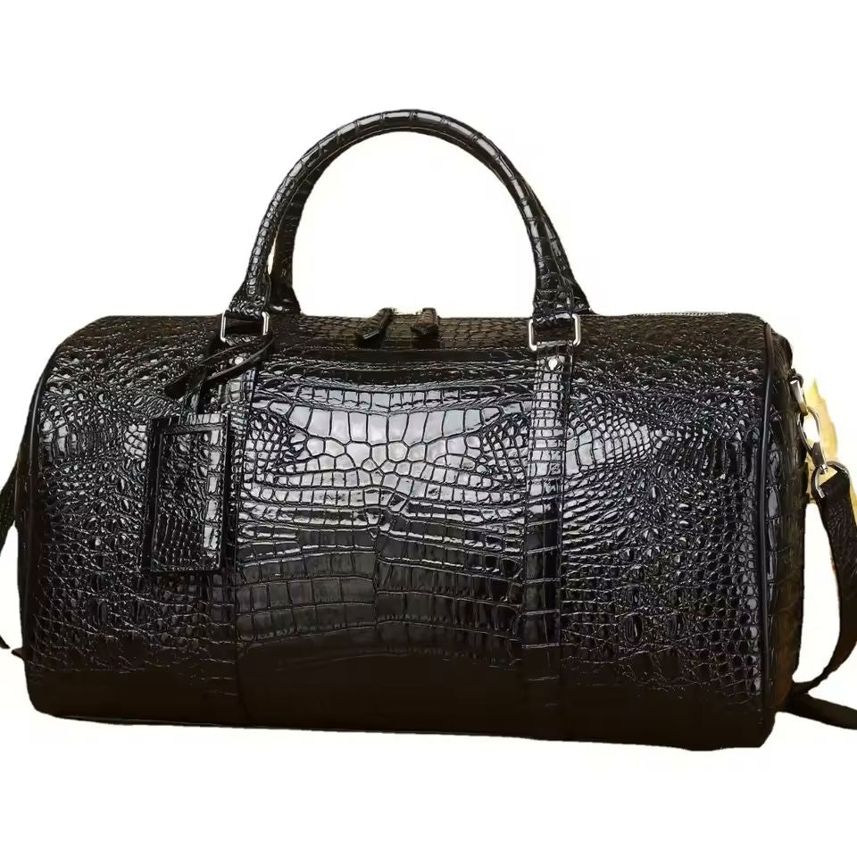 Black croc-embossed genuine leather duffle bag with dual top handles on white background
