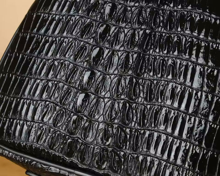 Namrico croc-pattern leather duffle bag front zip pocket close-up detail shot
