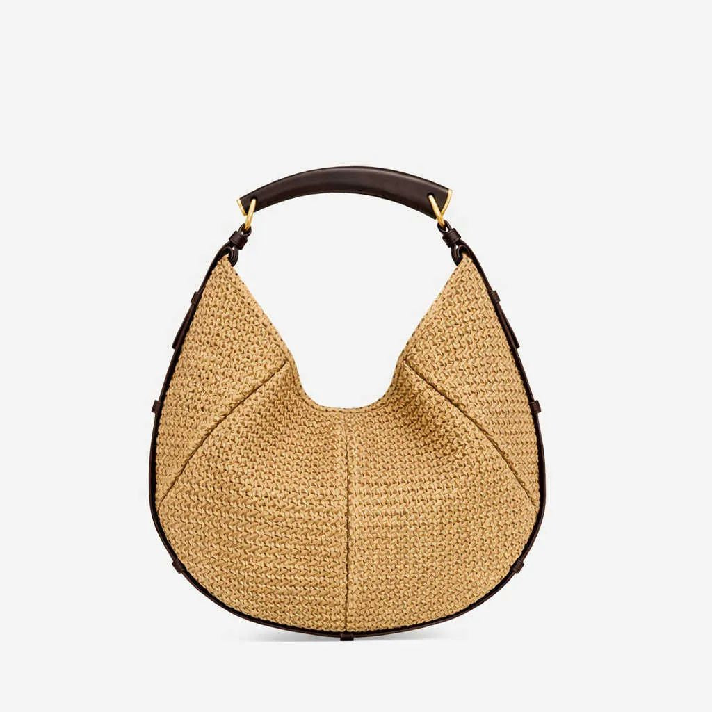 Beige woven handbag with black handle on a white background