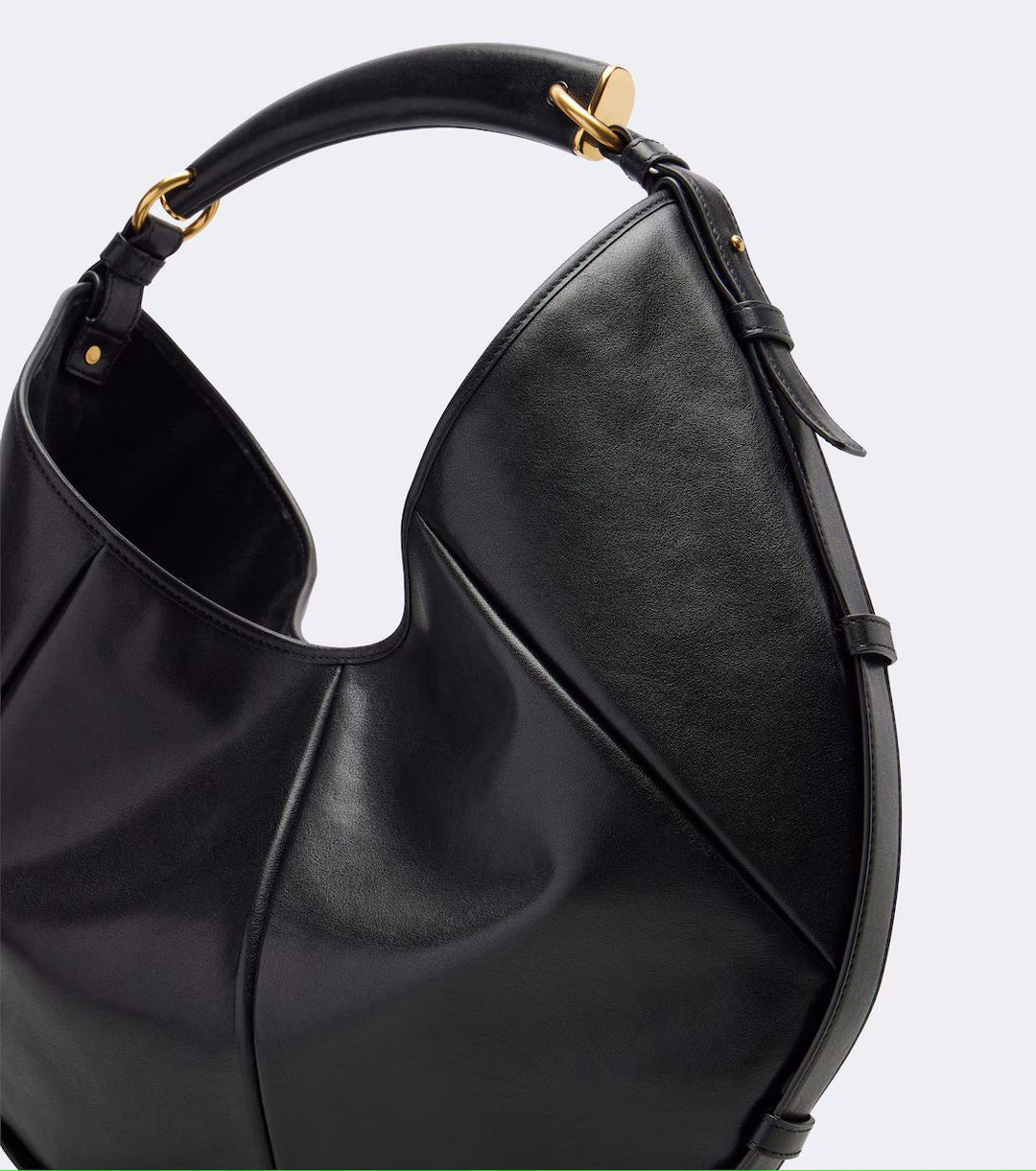 Black handbag with gold accents on a white background