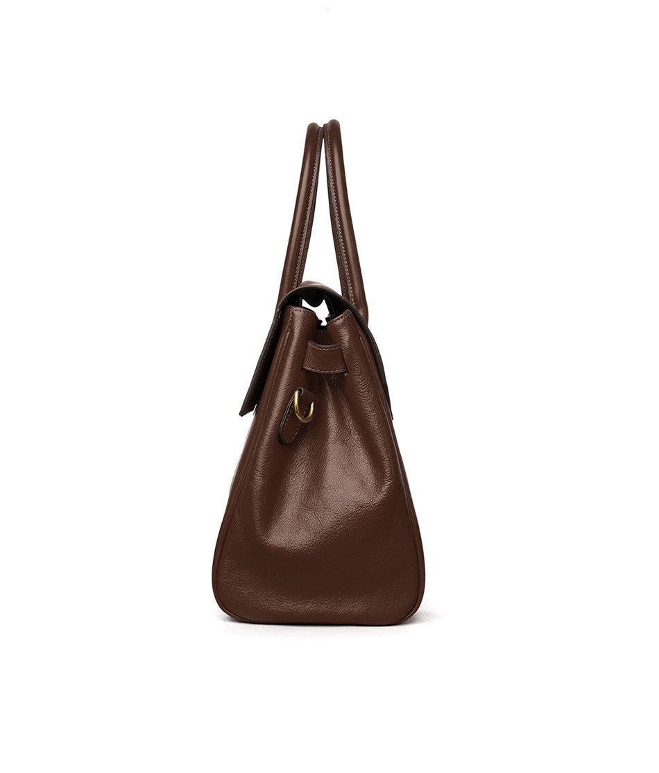 Brown leather handbag on a white background