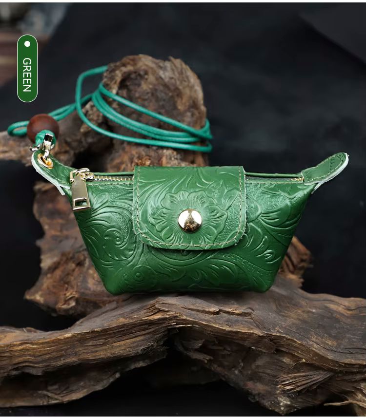 Blue genuine leather mini bag with floral emboss and gold snap closure product shot