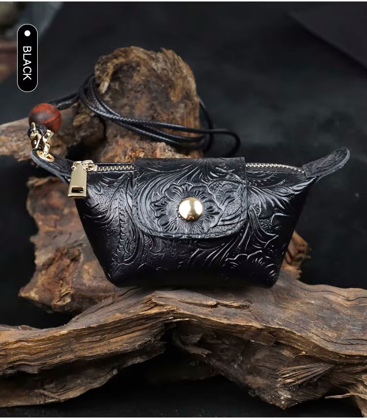 Green floral-embossed leather dumpling pouch with lanyard strap and bead tassel detail