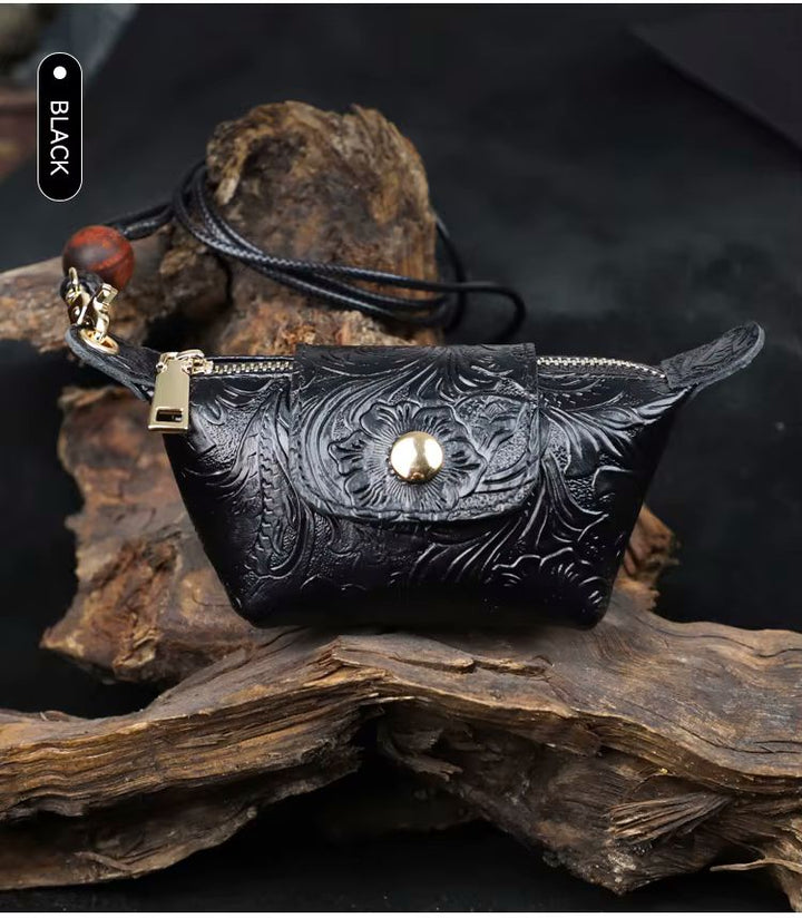 Green floral-embossed leather dumpling pouch with lanyard strap and bead tassel detail