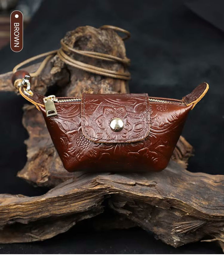 Namrico floral-embossed mini leather pouch close-up of wood bead charm and gold hardware