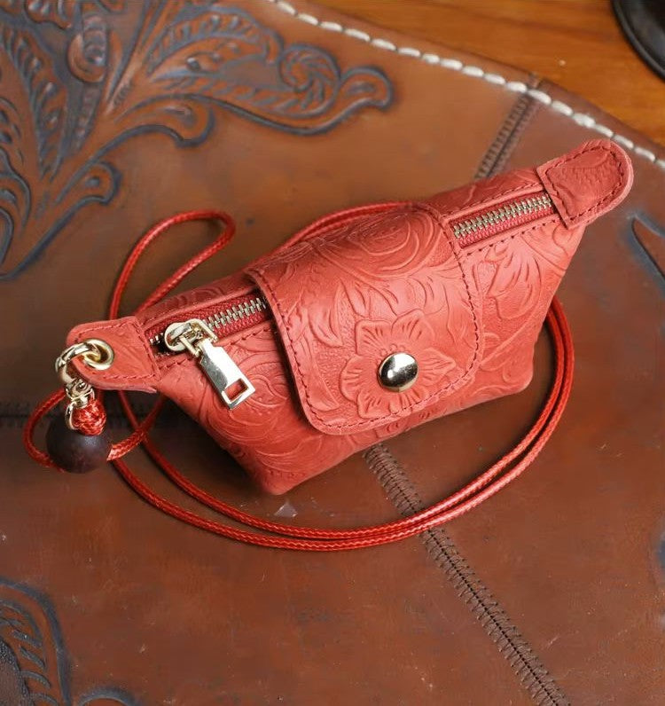 Purple handmade leather mini bag with floral relief pattern and thin crossbody lanyard