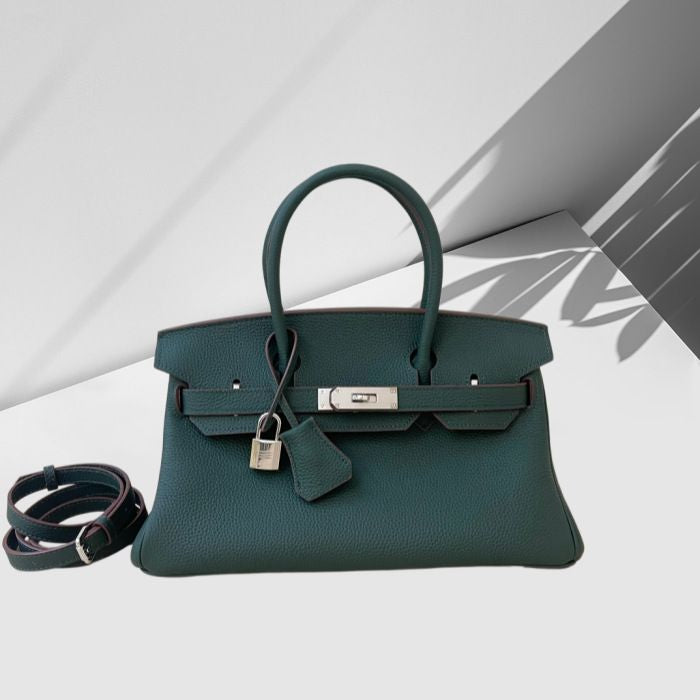 Green handbag with a strap on a white background