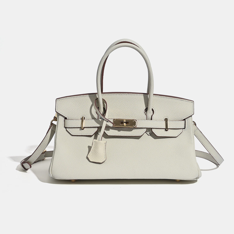 Brown leather luxury tote bag with adjustable crossbody strap and gold clasp hardware