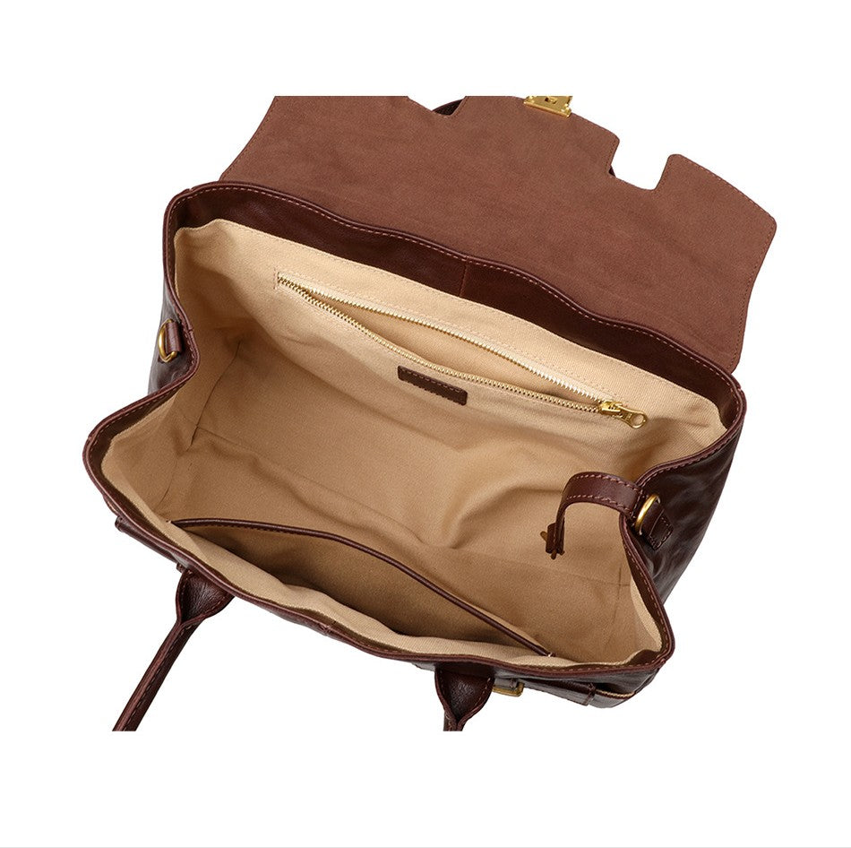 Brown leather bag with open interior on a white background