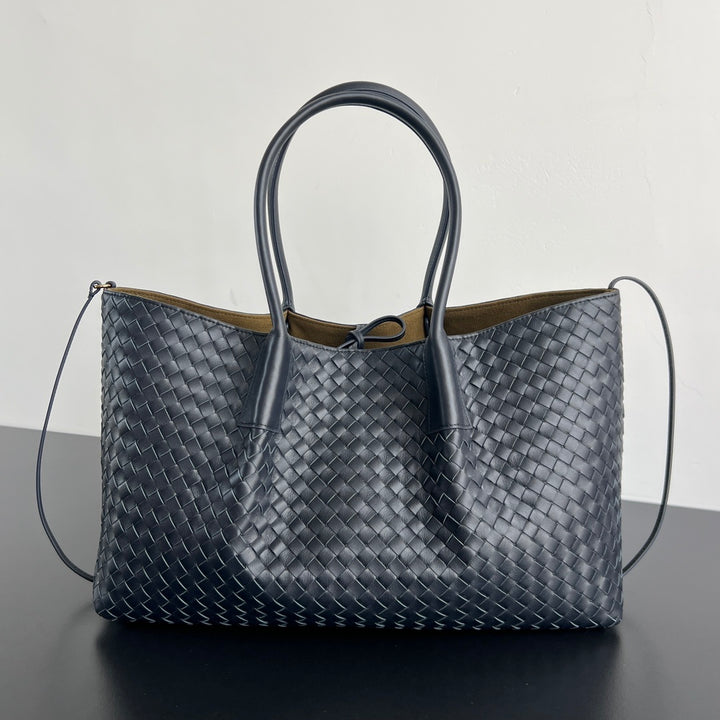 Luxury intrecciato woven leather tote bag in deep burgundy with dual top handles