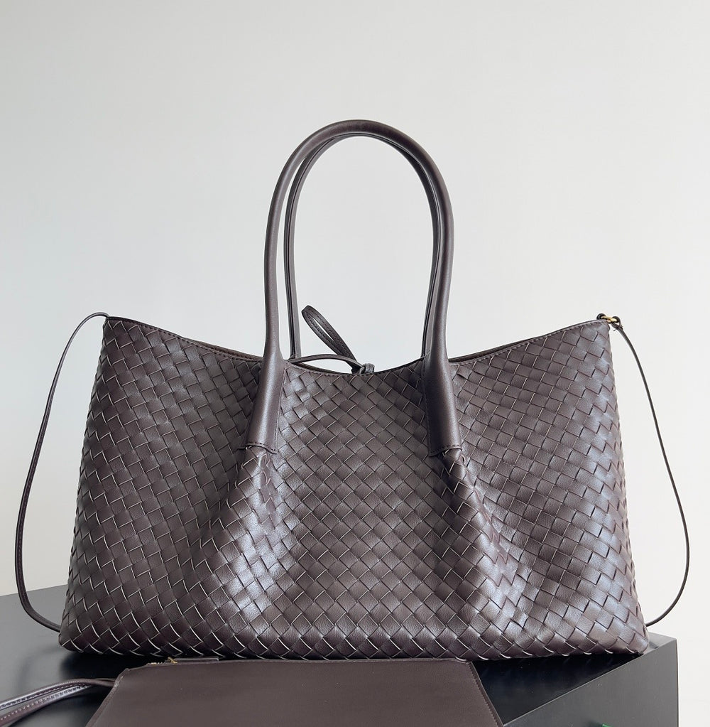 Large handwoven leather carryall in navy blue with soft structure and shoulder strap