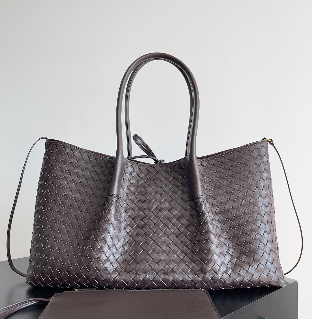 Large handwoven leather carryall in navy blue with soft structure and shoulder strap