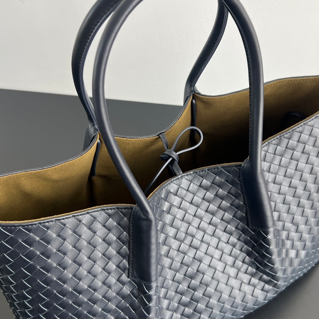 Unisex handwoven leather tote bag side view showing depth and woven texture detail