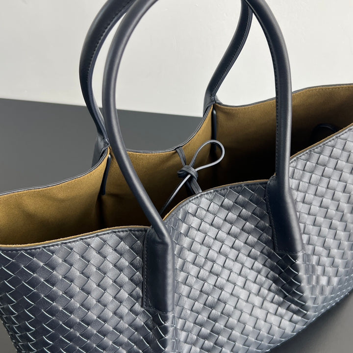 Unisex handwoven leather tote bag side view showing depth and woven texture detail