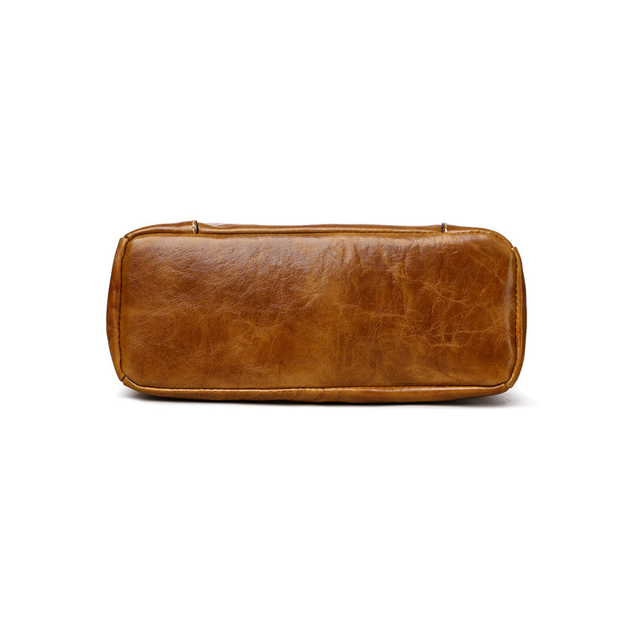 Tan leather tote with gold hardware and strap