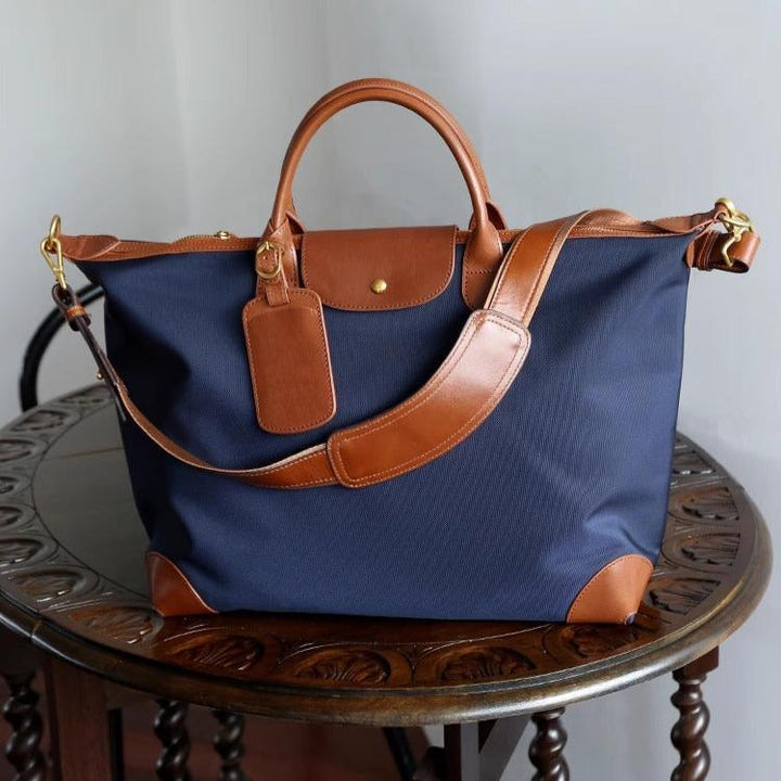Large navy nylon bag with gold snap closure