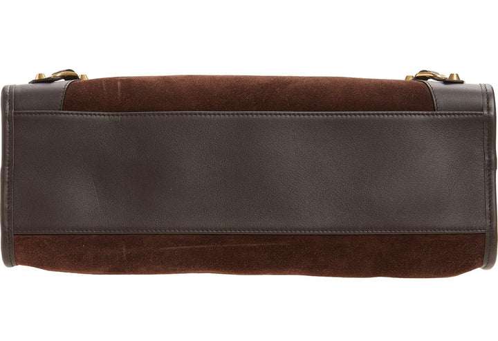 Brown leather bag with gold accents on a white background