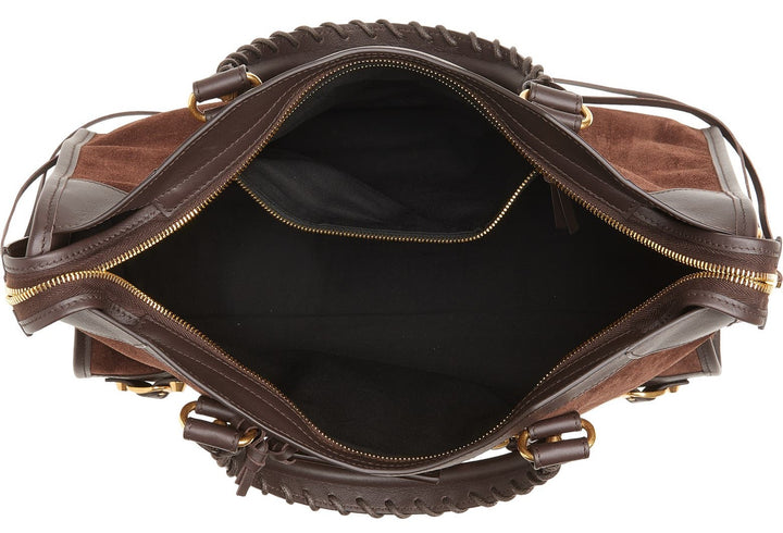 Interior view of black suede tote showing zipped pocket and fabric lining
