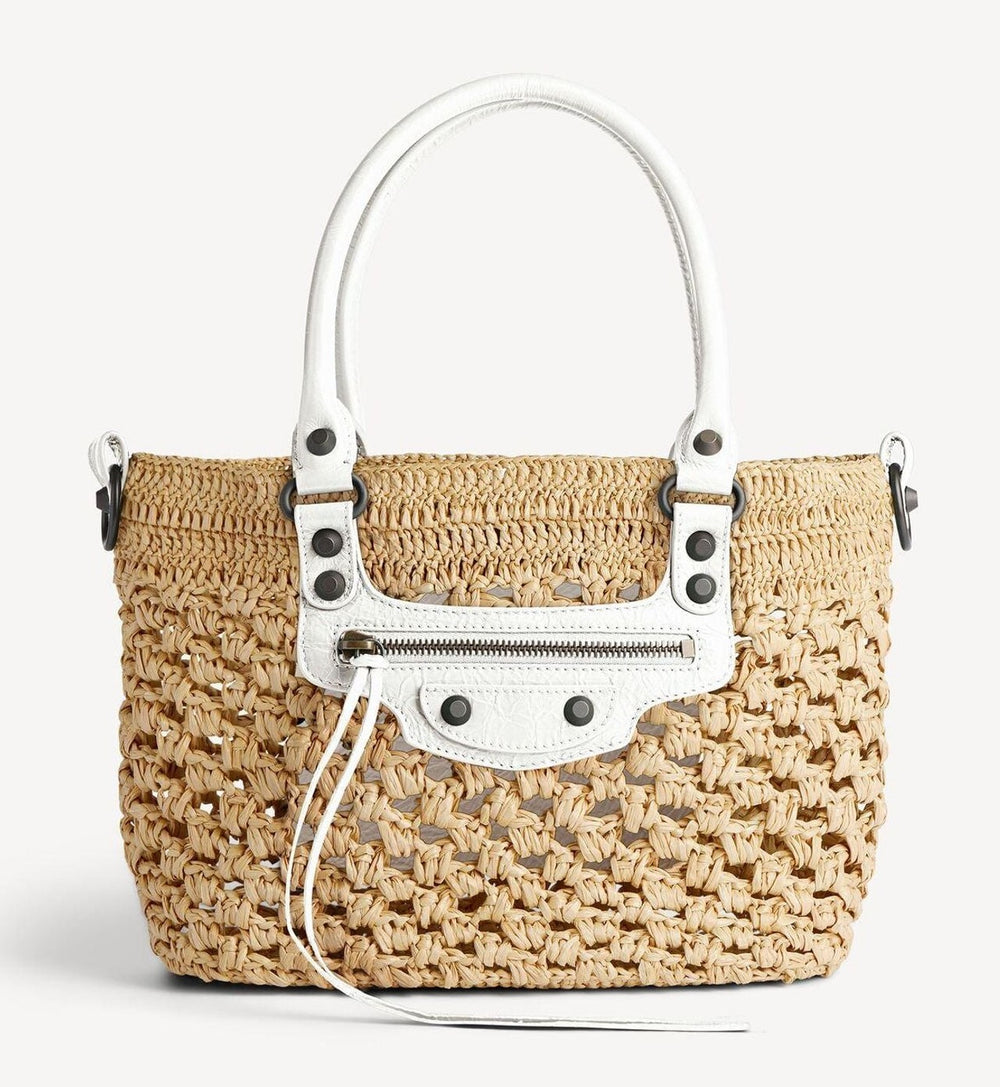 White raffia crochet bag with rolled leather shoulder straps studio product shot