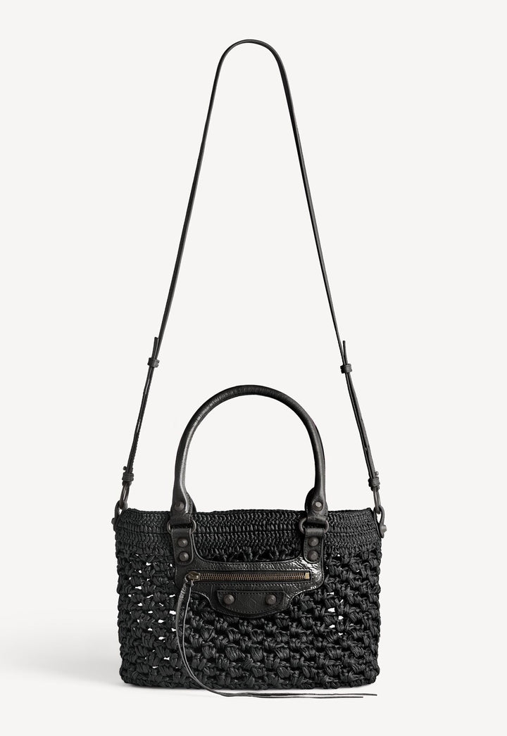 Black woven handbag with a shoulder strap on a white background