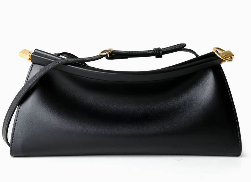 A black leather shoulder bag with a curved, slouchy silhouette, featuring gold-tone hardware and a matching black leather strap, shown against a plain white background.