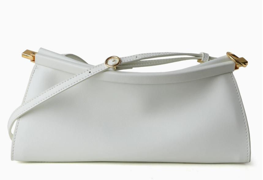 Namrico leather baguette bag side view showing compact horizontal silhouette and top handle