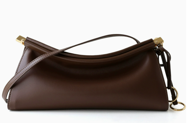 A dark brown leather shoulder bag with a slouchy crescent shape, featuring gold-tone hardware and a matching shoulder strap, set against a plain white background.
