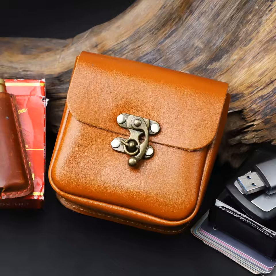 Leather key and card pouch flat lay showing all three colorways black brown and coffee