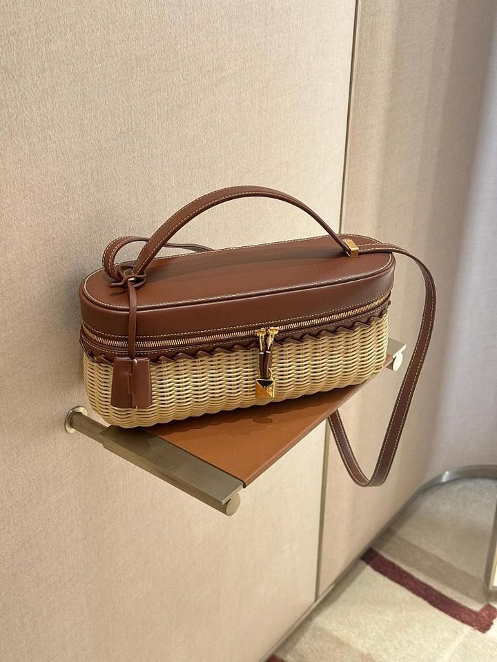 Elegant woven bamboo summer bag with leather handle and gold padlock detail