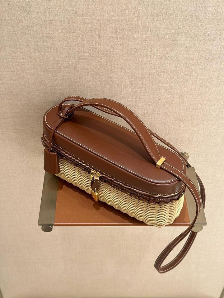 Brown handbag with a woven design on a beige background