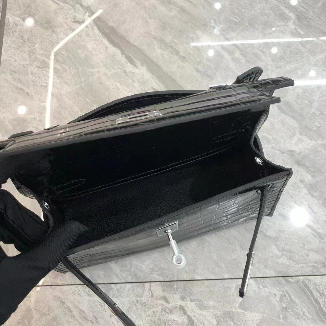 Black suitcase with a key on a reflective surface