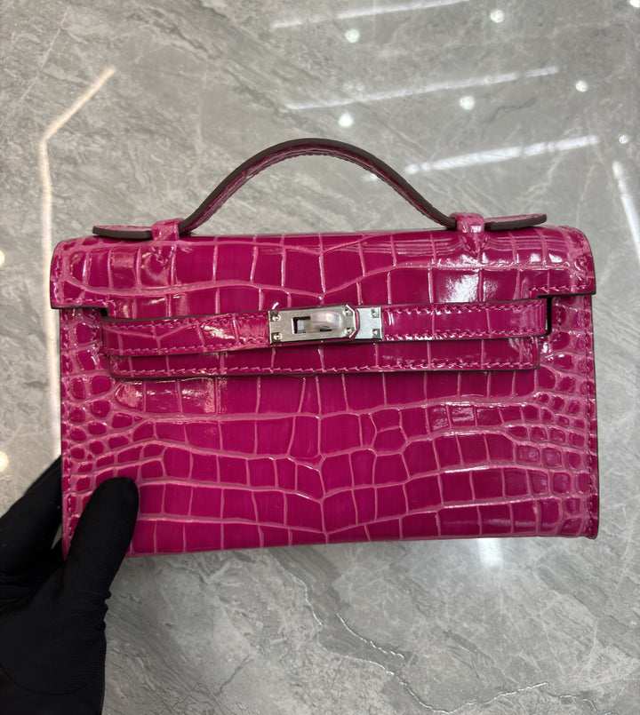 Royal blue croc-embossed leather flap bag side view showing structured boxy silhouette
