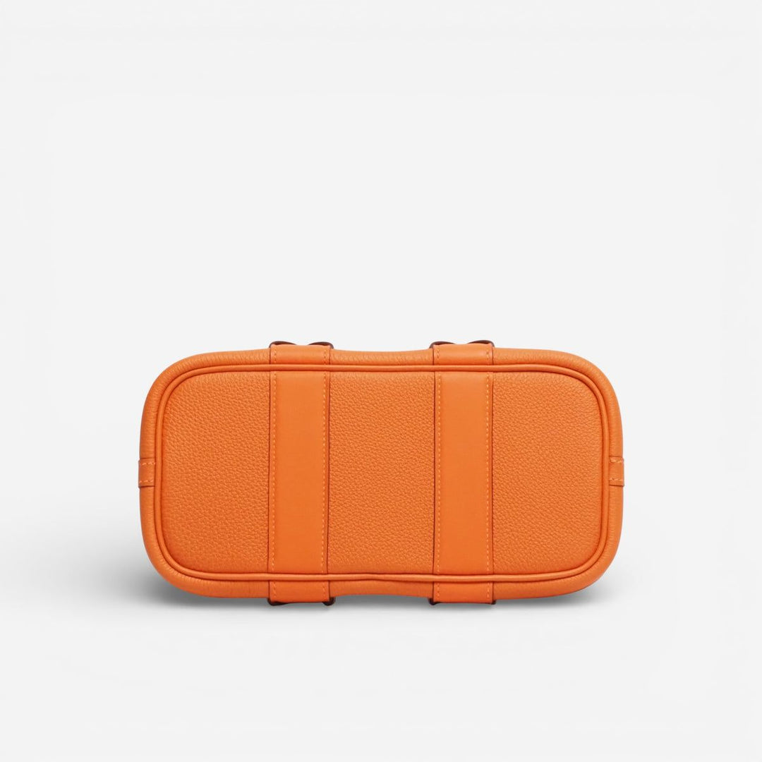 Orange hard-shell travel case on a light gray background