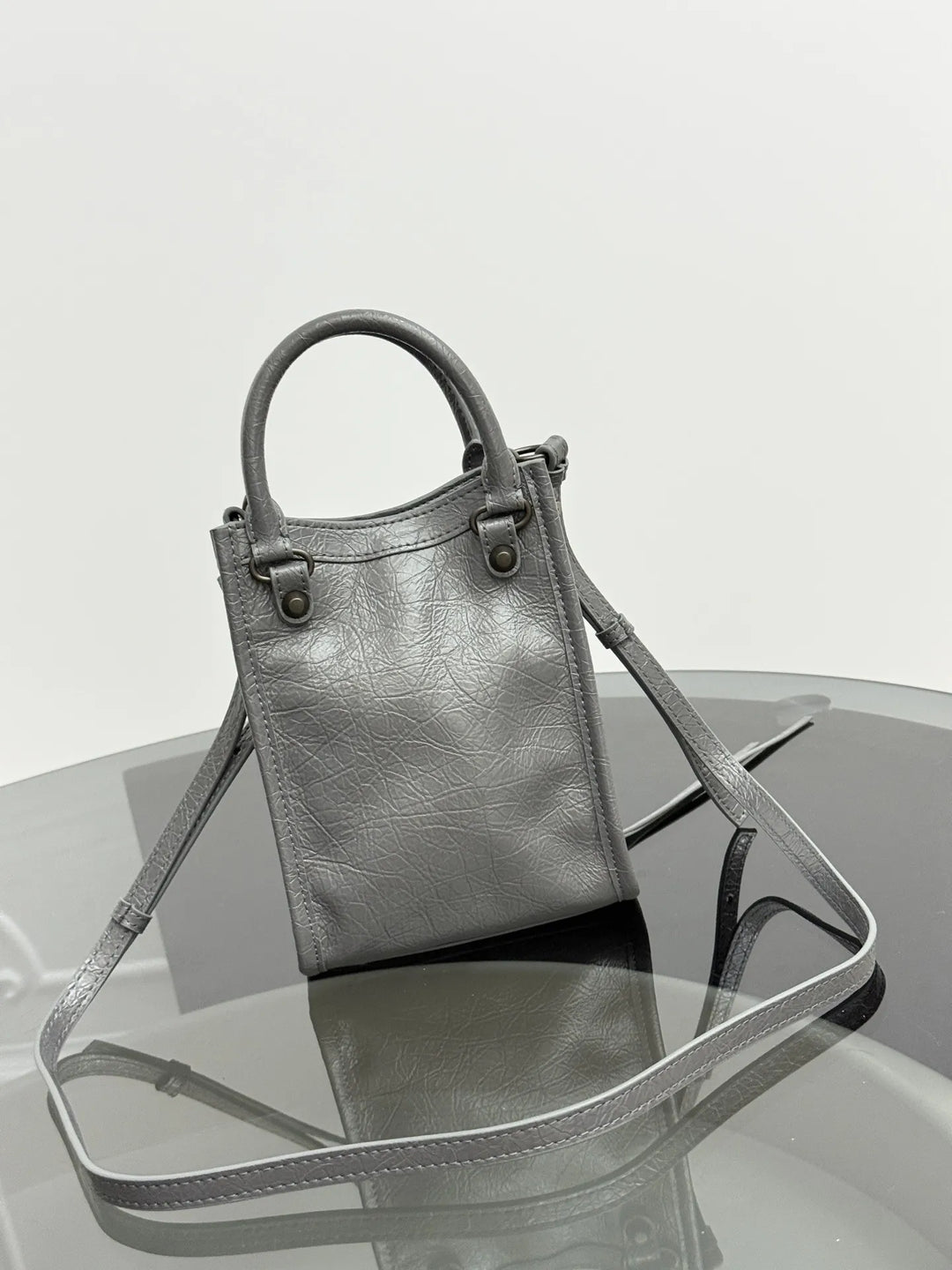 Namrico crinkled leather mini tote close-up of rivet and fringe embellishment detail