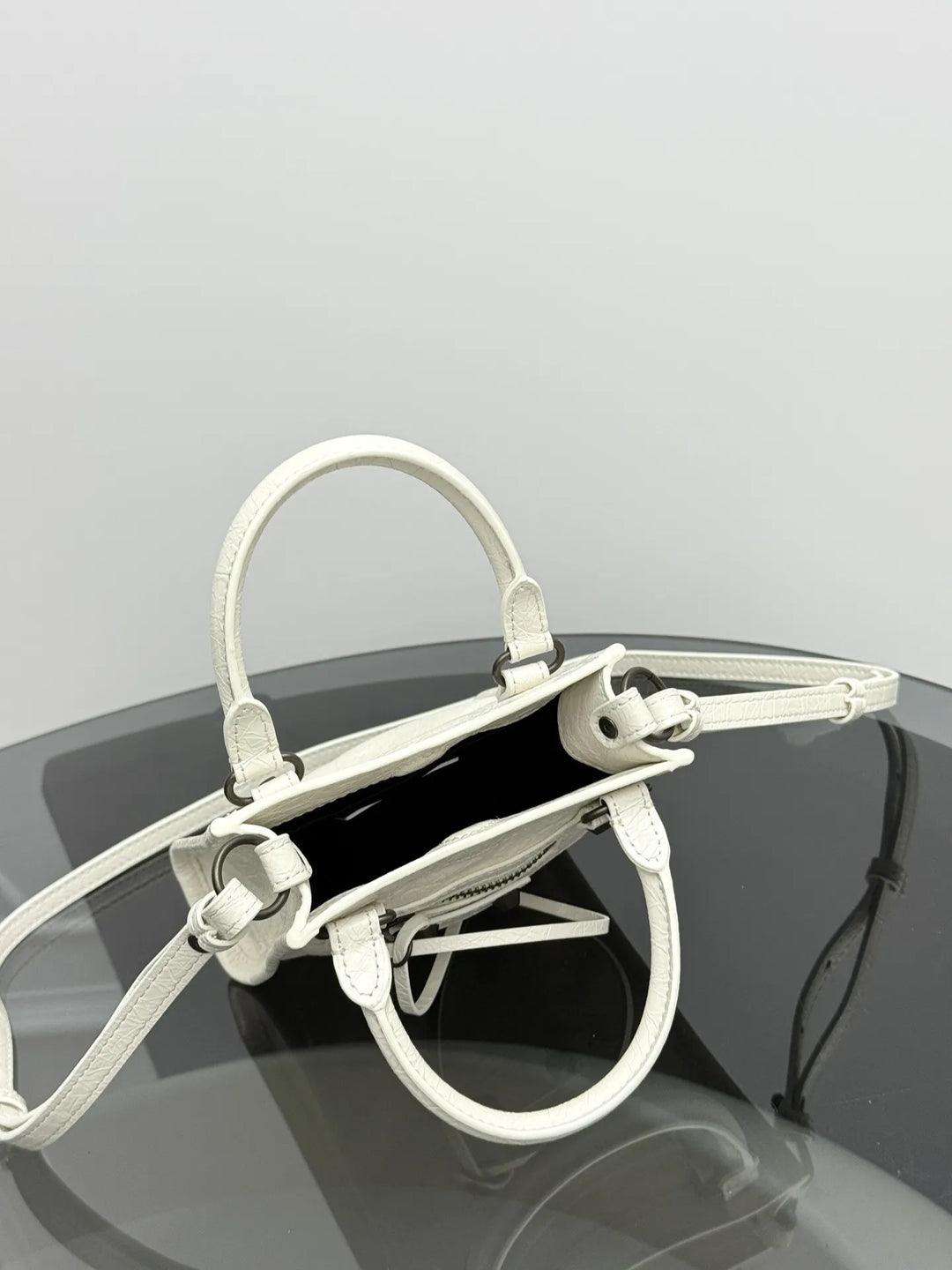 White crinkled genuine leather mini crossbody bag product shot on clean background