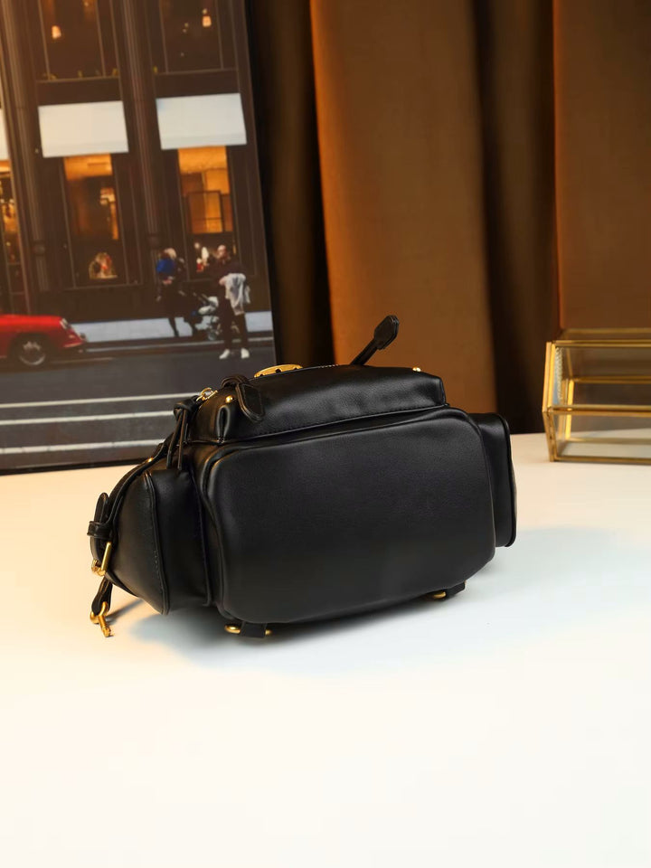 Black leather padlock shoulder bag with gold hardware and front zip pocket detail shot

