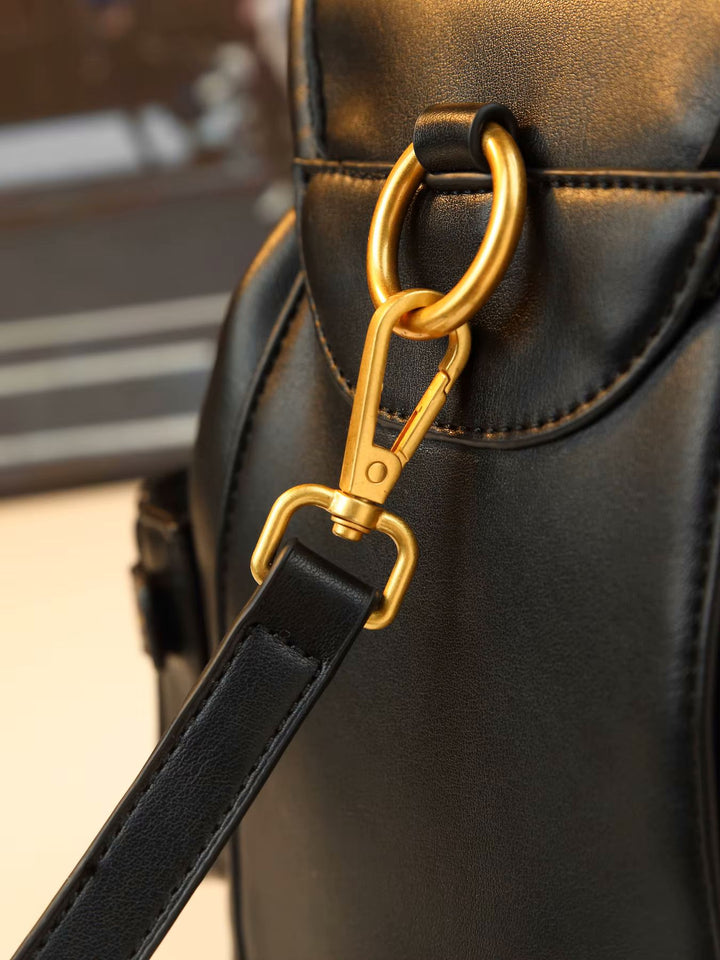 Black leather padlock shoulder bag with gold hardware and front zip