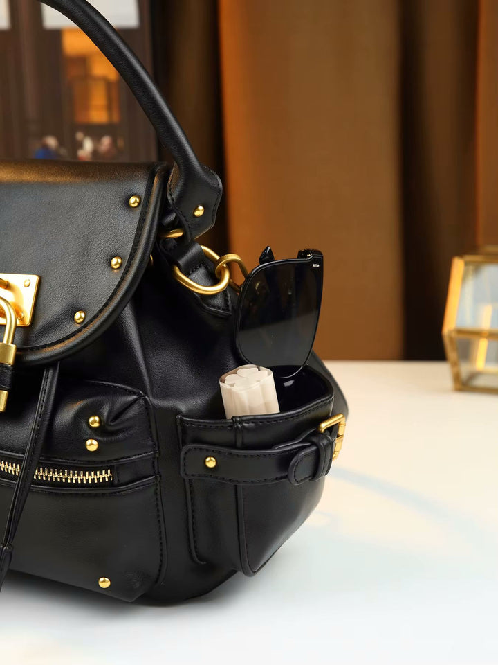 Black leather padlock shoulder bag with gold hardware and front zip pocket detail 