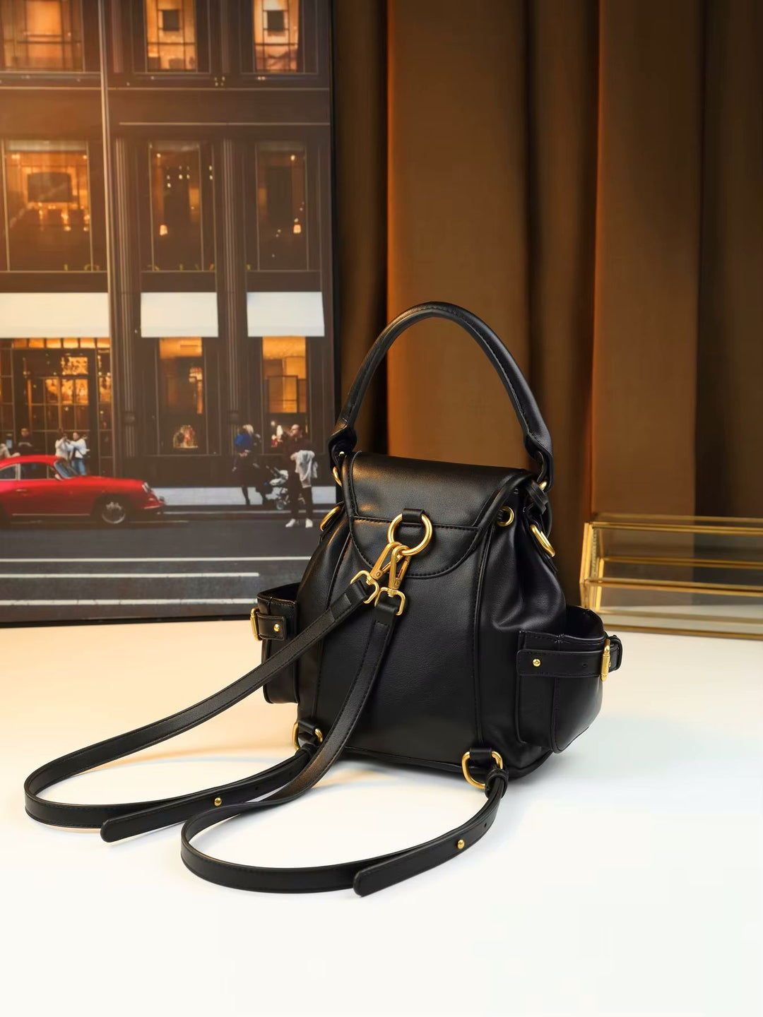 Gold padlock hardware close-up detail on studded soft leather flap shoulder bag
