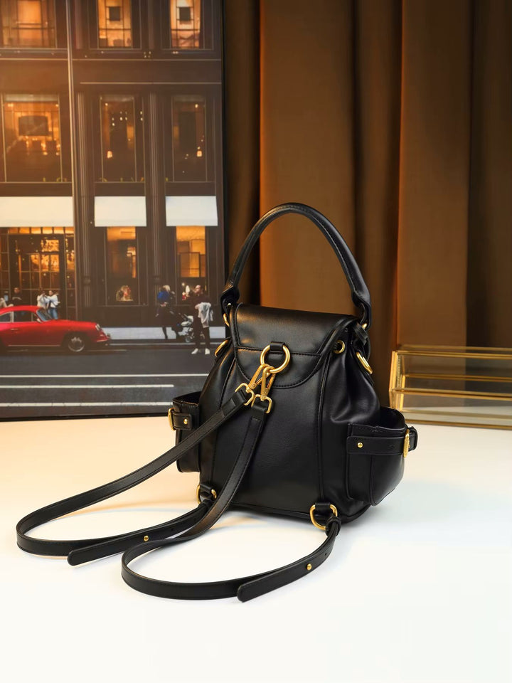 Gold padlock hardware close-up detail on studded soft leather flap shoulder bag
