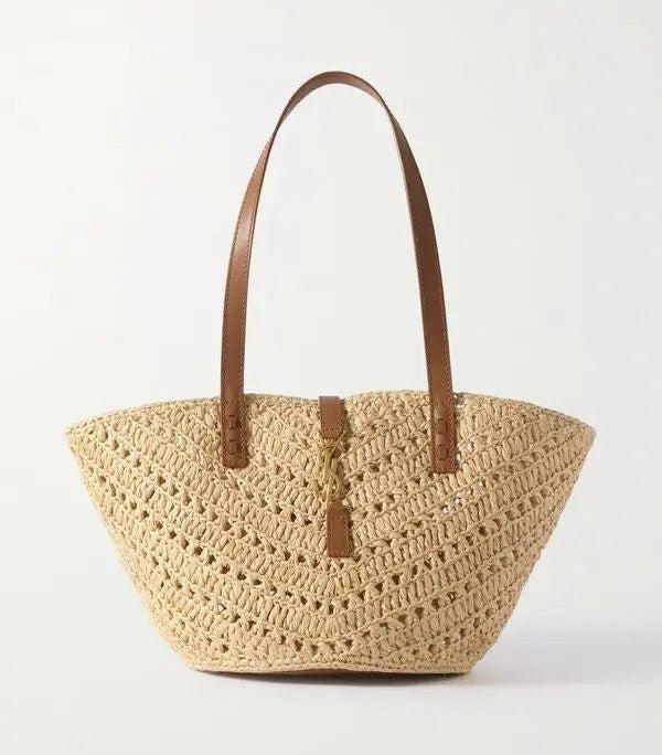 Beige woven raffia basket bag side view showing deep open body and leather trim details
