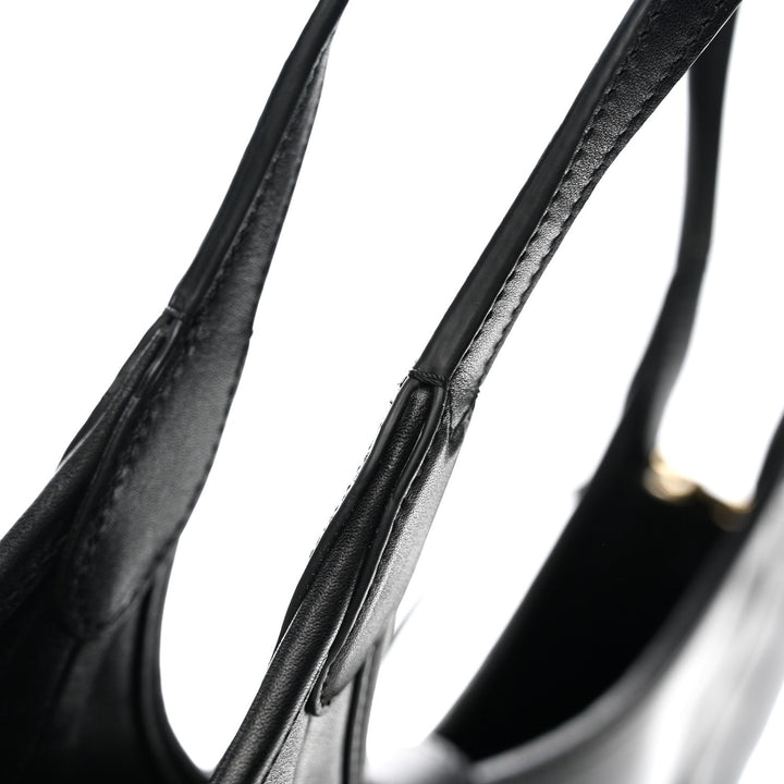 Close-up of a black bicycle wheel rim on a white background