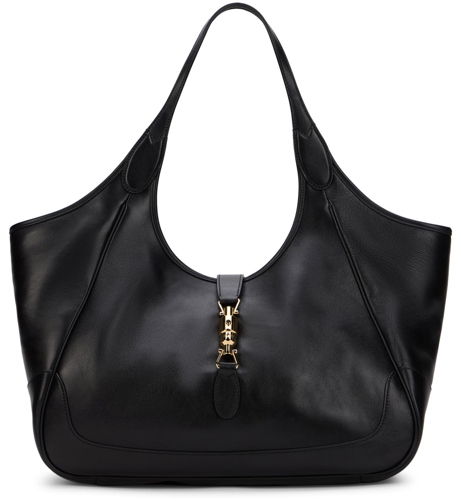 A black leather hobo-style shoulder bag with a gold-tone metal clasp closure on the front, photographed against a solid white background.