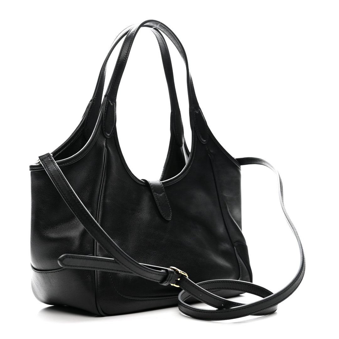 Black leather handbag with a shoulder strap on a white background