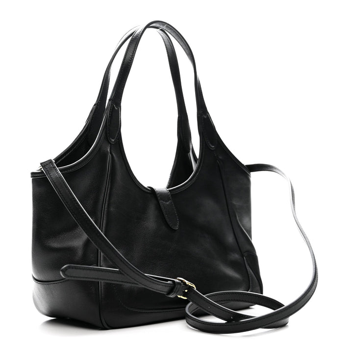 Black leather handbag with a shoulder strap on a white background