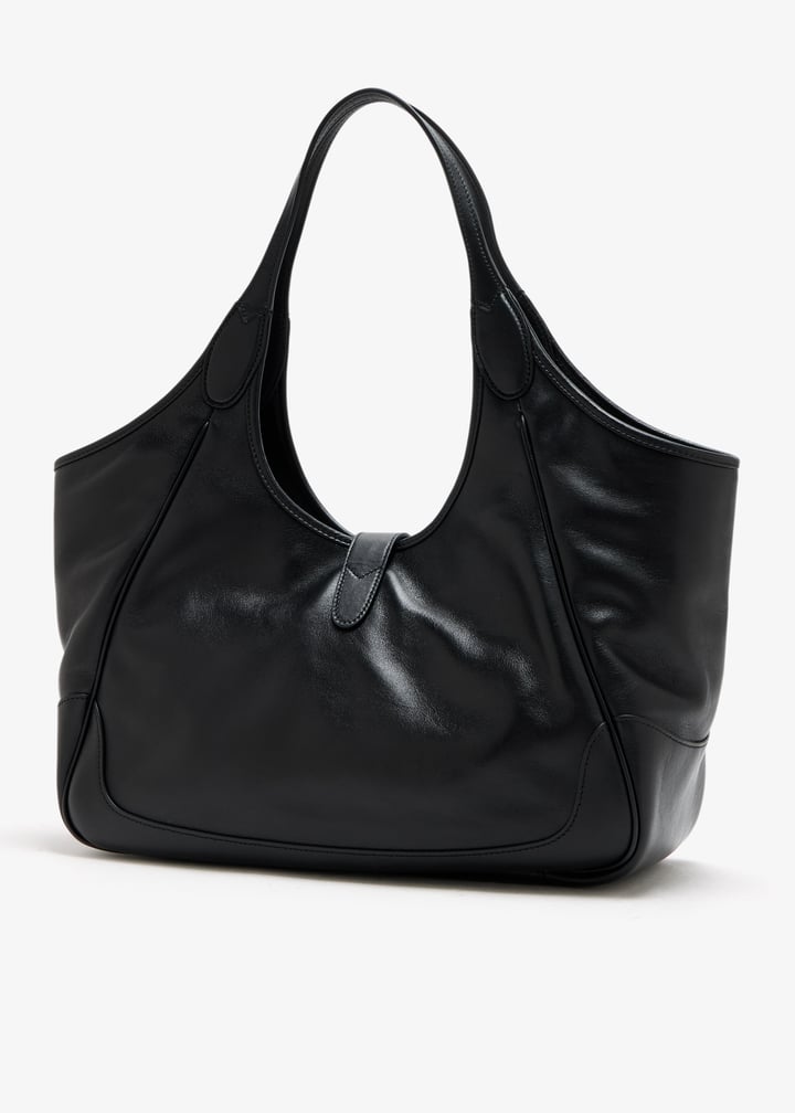 A black leather hobo shoulder bag with a slouchy silhouette and double shoulder straps, photographed on a clean white background.