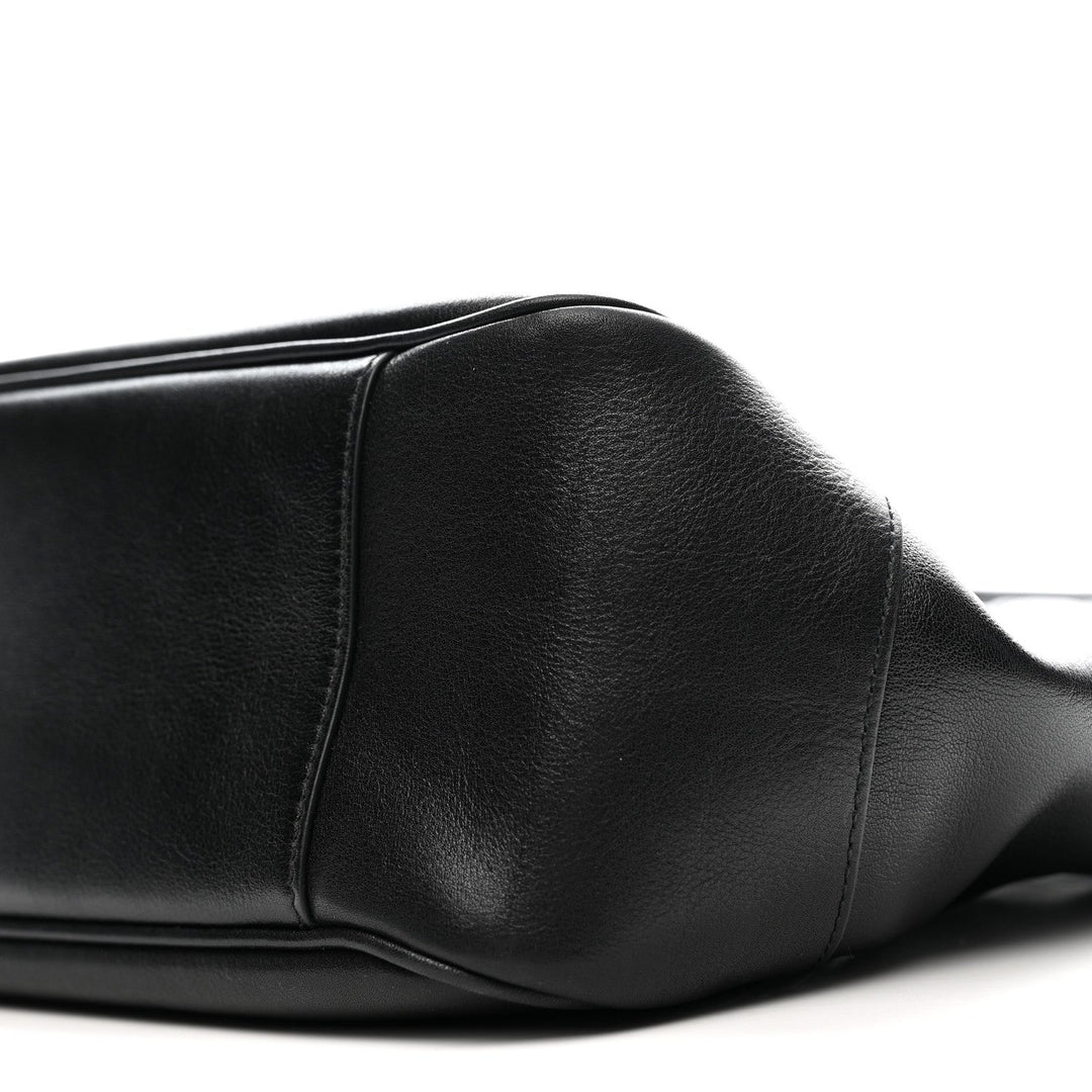 Close-up of a black leather seat on a white background