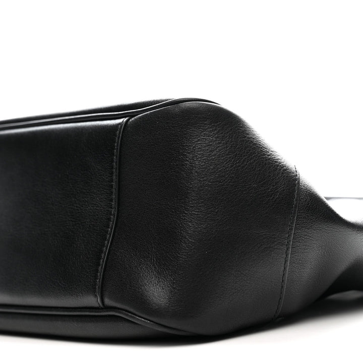Close-up of a black leather seat on a white background